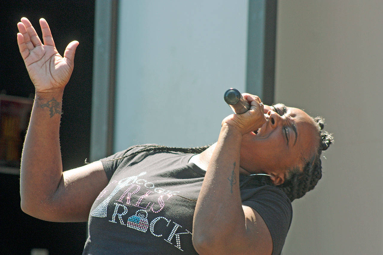 Christiana Hampton, part of the praise team, sings during the worship service at the Redeemed by the Blood Pentecostal Church on Sunday. MARK KLAAS, Kent Reporter