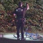 A police officer stands near the bike that was struck during a hit-and-run that killed a 34-year-old man in Federal Way on Friday. COURTESY PHOTO, Evergreen Media Production