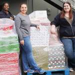 Camico Rivon, Kent Food Bank assistant director, far left, Jeniece Choate, Kent Food Bank executive director and Torklift Central employee Kerstin Stokes prepare last year to sort through donations collected during the Kent Turkey Challenge for the Kent Food Bank. COURTESY PHOTO, Torklift Central