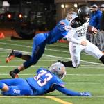 Kentwood quarterback Jackson Proctor dashes goal-ward as Auburn Mountainviews Teagin Child and Cooper White (33) pursue during NPSL first-half play Friday night. RACHEL CIAMPI, Kent Reporter