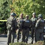 King County Sheriffs Office detectives and SWAT team members debrief at the scene of an officer-involved shooting on Wednesday afternoon in Federal Way. OLIVIA SULLIVAN, Federal Way Mirror