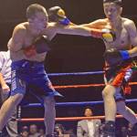 Kents Willie Gomez lands a right punch against Steven Hellman during their junior welterweight bout at the Fight Night, Fright Night Brawl Series on Saturday night at Green River College. COURTESY PHOTO