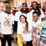 The Seahawks Demarcus Christmas, left, Branden Jackson, middle, and Jadeveon Clowney helped deserving kids shop for gifts at the Southcenter Target store in Tukwila on Tuesday. COURTESY PHOTO, Red Fish Blue Fish Photography