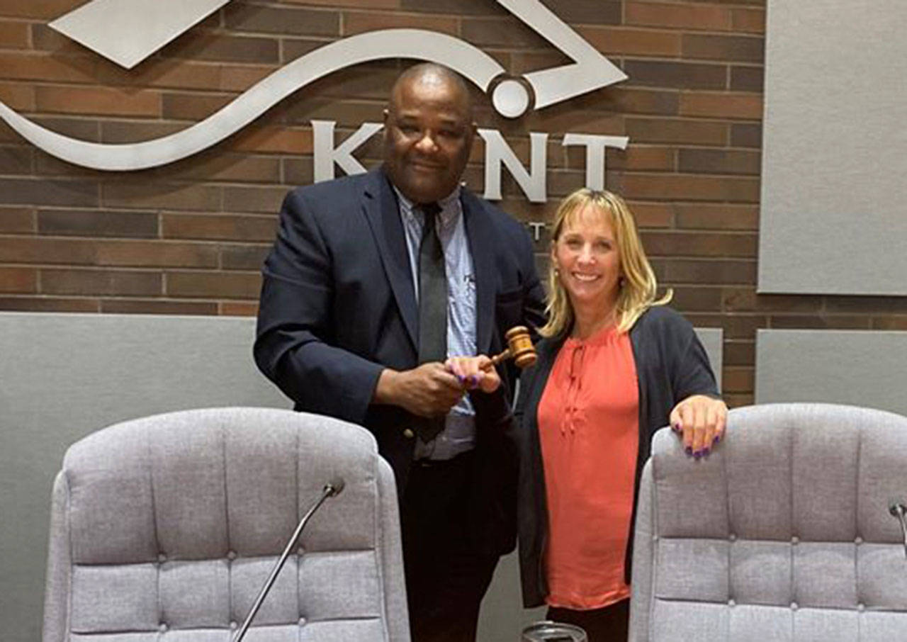 Kent City Council President Bill Boyce passes the gavel Tuesday to Councilmember Toni Troutner who will become the new council president on Jan. 1. Boyce will remain as one of the seven council members. COURTESY PHOTO, City of Kent