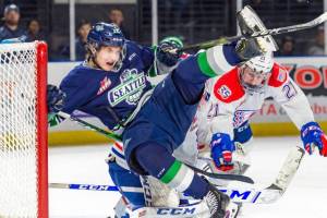 Thunderbirds center Henrik Rybinski collides with Spokane defenseman Bobby Russell in front of Chiefs goalie Campbell Arnold during WHL play Saturday night. COURTESY PHOTO, Brian Liesse, T-Birds