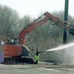 Crews work Tuesday to remove old artificial turn from the Riverbend Driving Range. MARK KLAAS, Kent Reporter