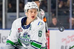 Thunderbirds defenseman Tyrel Bauer pursues a flying puck during WHL play Saturday night. COURTESY PHOTO, Brian Liesse, T-Birds