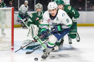 The Thunderbirds Keltie Jeri-Leon handles the puck in front of the Silvertips Ethan Regnier and goalie Dustin Wolf during WHL action Sunday at the accesso ShoWare Center. COURTESY PHOTO, Brian Liesse, T-Birds