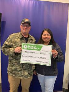 Martin Coon and his wife Khristine hold the $75,000 check after winning Washingtons Lottery. Courtesy photo