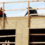 Crews work on the back row of units at the Midtown 64 Apartments along West Meeker Street in Kent. STEVE HUNTER, Kent Reporter