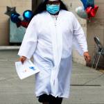 A student makes the graduation walk July 7 across the Kent-Meridian campus. STEVE HUNTER, Kent Reporter