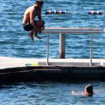 A swimmer jumps off the dock into Lake Meridian on Monday, July 13. STEVE HUNTER, Kent Reporter
