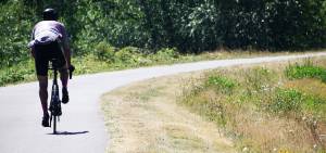 Pedal power                                A bicyclist heads down the Green River Trail on Monday afternoon in Kent behind The Ethos Apartments that replaced the former Riverbend par 3 golf course.                                STEVE HUNTER, Kent Reporter