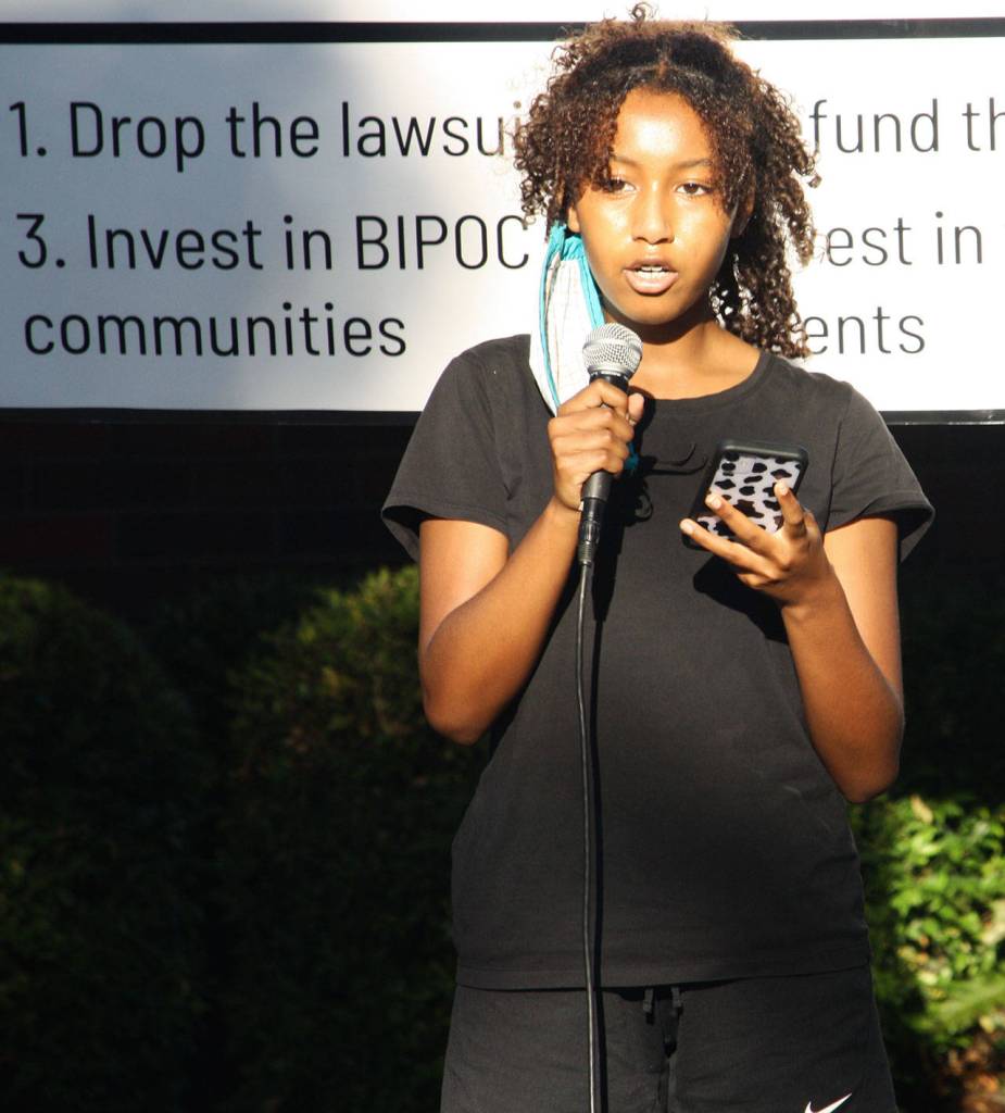 Baeza Lakew, a senior at Kentlake High School, speaks at a protest rally Aug. 17 outside of the Kent Police Department. STEVE HUNTER, Kent Reporter