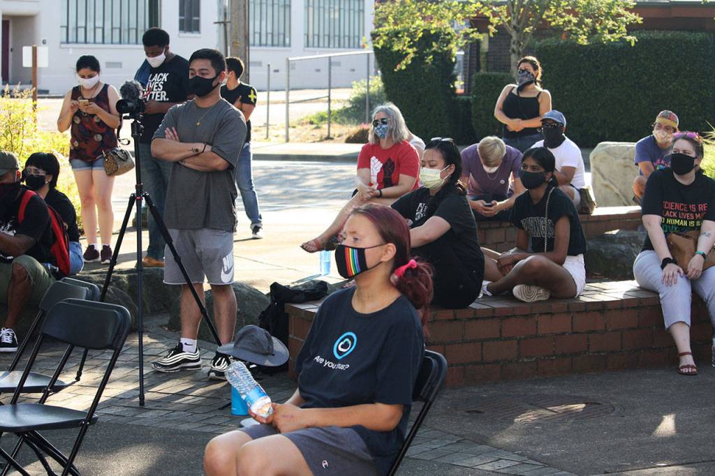 People listen to speakers at a protest rally Aug. 17 outside of the Kent Police Department. STEVE HUNTER, Kent Reporter