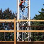 A construction crew member on Tuesday, Aug. 25, scrambles down the crane in place to build the Madison Plaza Apartments in Kent, 102 Madison Ave. N. STEVE HUNTER, Kent Reporter