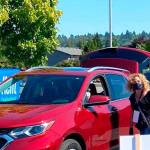 Vehicles line up during a free distribution of food, face masks and hand sanitizers on Aug. 28 at the accesso ShoWare Center. COURTESY PHOTO, City of Kent