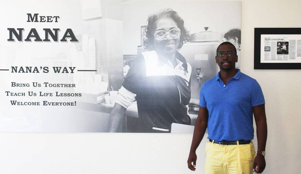 Todd Minor stands next to a photo of his great grandma Myrtle Henderson or Nana, the inspiration for opening Nanas Southern Kitchen in Kent. STEVE HUNTER, Kent Reporter