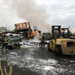 Firefighters methodically remove vehicles from the pile to complete extinguishment early Tuesday, Sept. 1 at a wrecking yard in the 26100 block of 78th Avenue South in Kent. COURTESY PHOTO, Puget Sound Fire