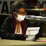 A woman closely studies her ballot at the Vote Center Tuesday, Nov. 3 inside the accesso ShoWare Center. STEVE HUNTER, Kent Reporter