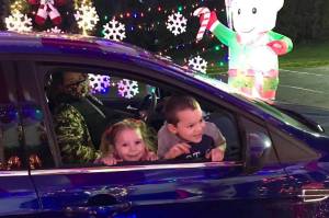 Two children check out the Candy Cane Lane drive-thru event that was open Saturday, Dec. 12, at Hogan Park and outside the Kent Valley Ice Centre. COURTESY PHOTO, City of Kent