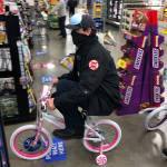 A firefighter test rides a bicycle during a purchase of toys as part of the annual Toys for Joy drive in Kent and Covington. COURTESY PHOTO, Puget Sound Fire