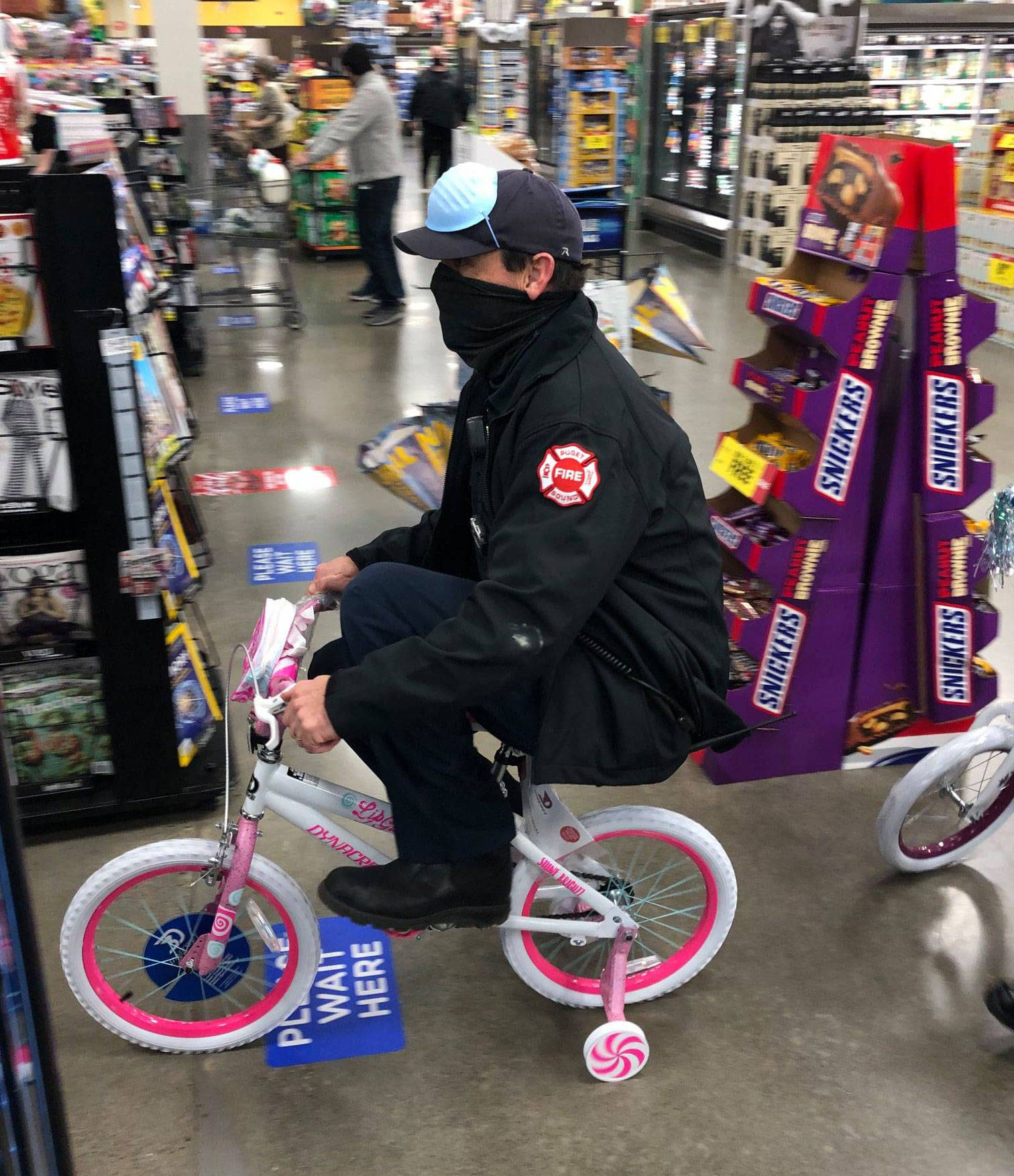 A firefighter test rides a bicycle during a purchase of toys as part of the annual Toys for Joy drive in Kent and Covington. COURTESY PHOTO, Puget Sound Fire