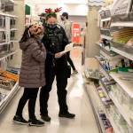 A Kent Police officer helps a child shop during the annual Shop with a Cop day Dec. 19 at the Kent Target store. COURTESY PHOTO, Kent Police