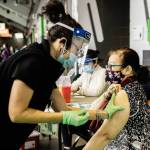 Dieu Tran, of Renton, receives the COVID-19 vaccine on Feb. 1 in the concourse of the accesso ShoWare Center in Kent. COURTESY PHOTO, King County