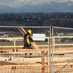 A crew member carries lumber during early construction of the Alexan Gateway Apartments Feb. 9 along Military Road South in Kent near Veterans Drive. STEVE HUNTER, Kent Reporter