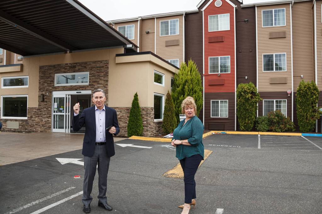 King County Executive Dow Constantine and Auburn Mayor Nancy Backus stand in front of the Clarion Hotel in Auburn on Tuesday July 20. The hotel will be used to house approximately 100 people experiencing homelessness in the area as part of the countys Health Through Housing program. Photo by Henry Stewart-Wood.
