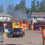 Puget Sound Fire firefighters extinguish a house fire the morning of Friday, Sept. 24 in the 25200 block of 37th Place South on Kents West Hill. COURTESY PHOTO, Puget Sound Fire