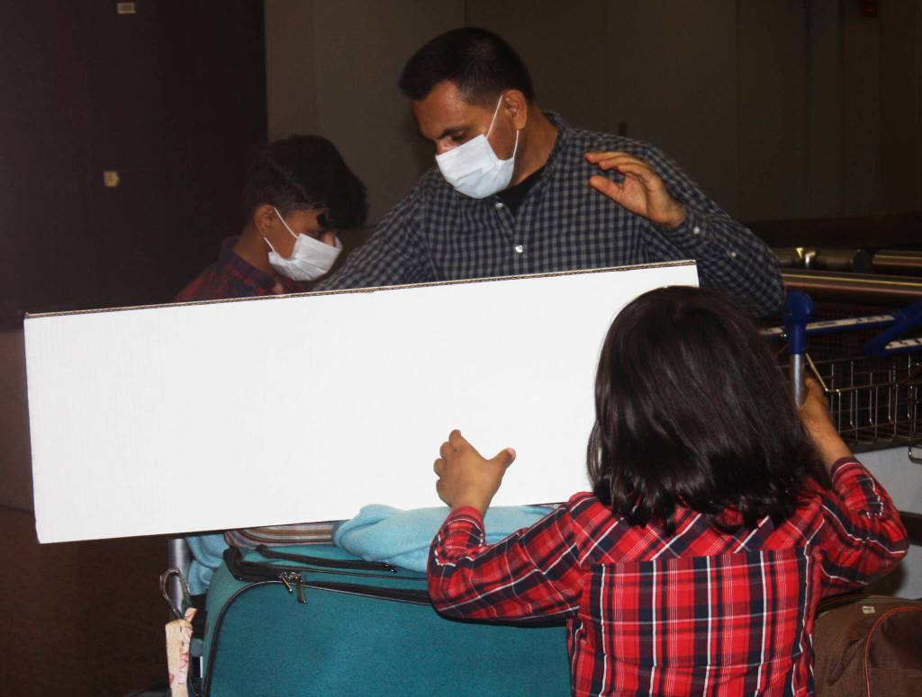 The Azizulla Jabarkhail family loads up luggage Oct. 1 at Sea-Tac Airport to head home to Kent. STEVE HUNTER, Kent Reporter