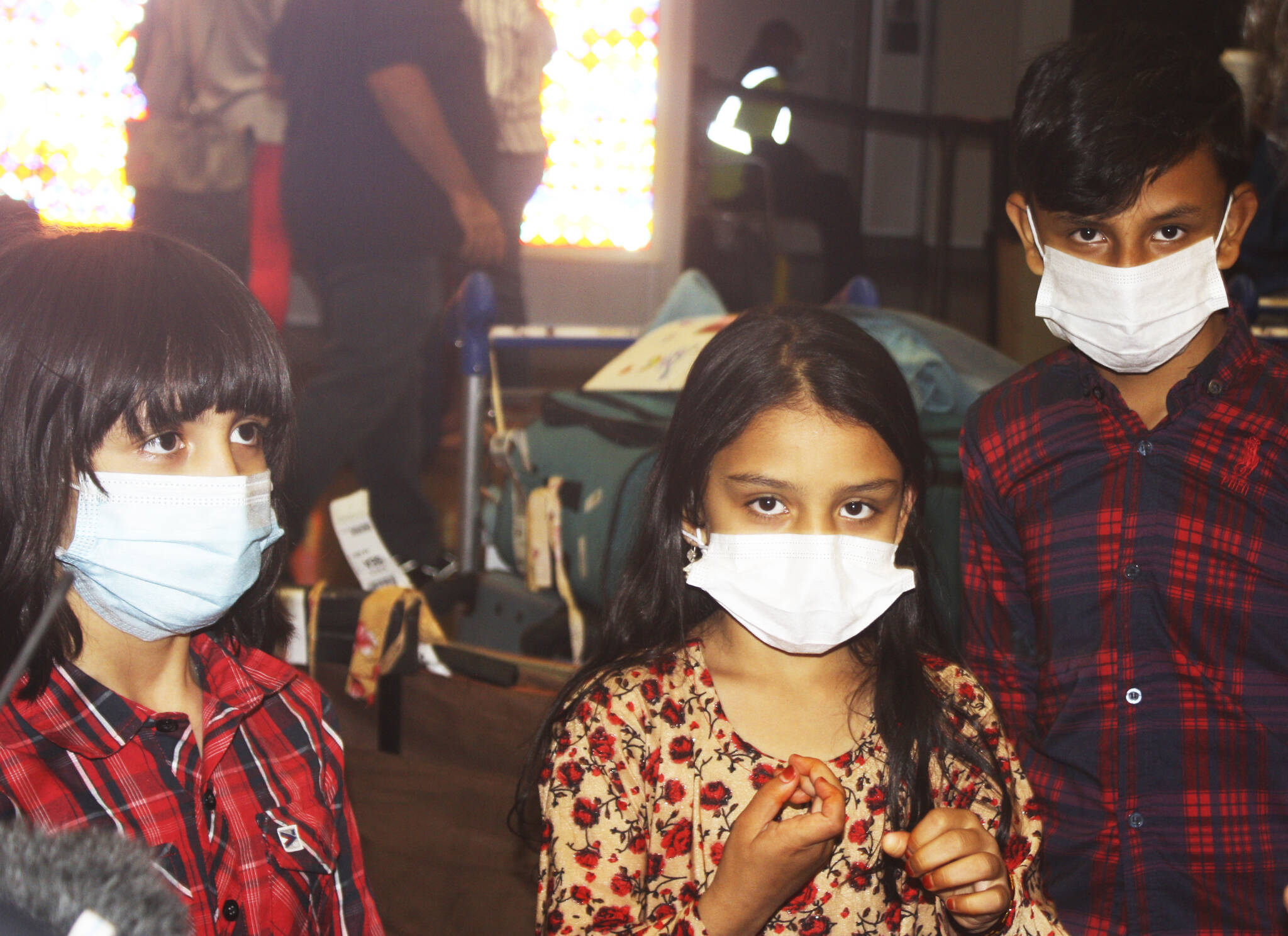 The three children of Kent resident Azizulla Jabarkhail return home safely Oct. 1 at Sea-Tac Airport from Afghanistan after help from Afghan war veterans. STEVE HUNTER, Kent Reporter