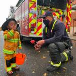 A costumed firefighter and a real firefighter share a moment Oct. 24 at the Haunted Boo-Levard at Kent Station. COURTESY PHOTO, Kent Station