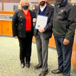 Kent Mayor Dana Ralph, left, and City Councilmember Bill Boyce, right, on Nov. 2 at City Hall present the Marge Williams Day proclamation to Harry Williams, the husband of the late Marge Williams. COURTESY PHOTO, City of Kent