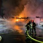 Firefighters spray water at a carport engulfed in flames at the Riverfront Apartment complex on 8th Street Southeast in Auburn. The apartment complex was engulfed in a three-alarm fire Sunday night. Photo courtesy of Valley Regional Fire Authority.