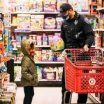 A Kent Police officer helps a child select gifts during the eighth annual Shop with a Cop Dec. 4 at Target. COURTESY PHOTO, Kent Police Department