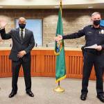 Robert Hollis, left, a former Kent Police commander, is sworn in Dec. 8 as deputy chief for the Lacey Police Department. COURTESY PHOTO, Lacey Police