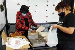 Meals are packed for the Christmas Day dinner giveaway by Nanas Southern Kitchen. The restaurant distributed about 1,200 free meals between its two locations in Kent and Covington. COURTESY PHOTO, Nanas Southern Kitchen