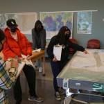 Students use a stream table to determine the streams discharge in a geology lab taught by Highline College geology instructor Carla Whittington. Photo courtesy of Highline College