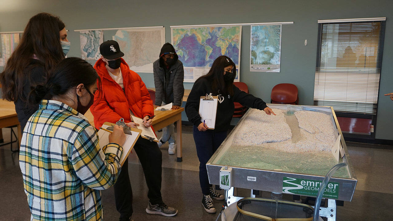 Students use a stream table to determine the streams discharge in a geology lab taught by Highline College geology instructor Carla Whittington. Photo courtesy of Highline College