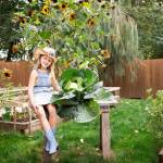 Maeryn Nau, of Kent, sits next to her winning cabbage that earned her $1,000 for the best cabbage in the state. COURTESY PHOTO,