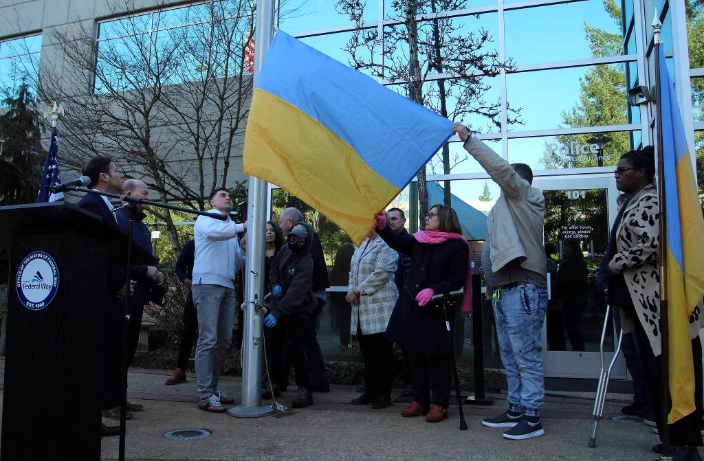 Elected officals help raise the Ukrainian flag on Friday, Feb. 25. Olivia Sullivan/the Mirror