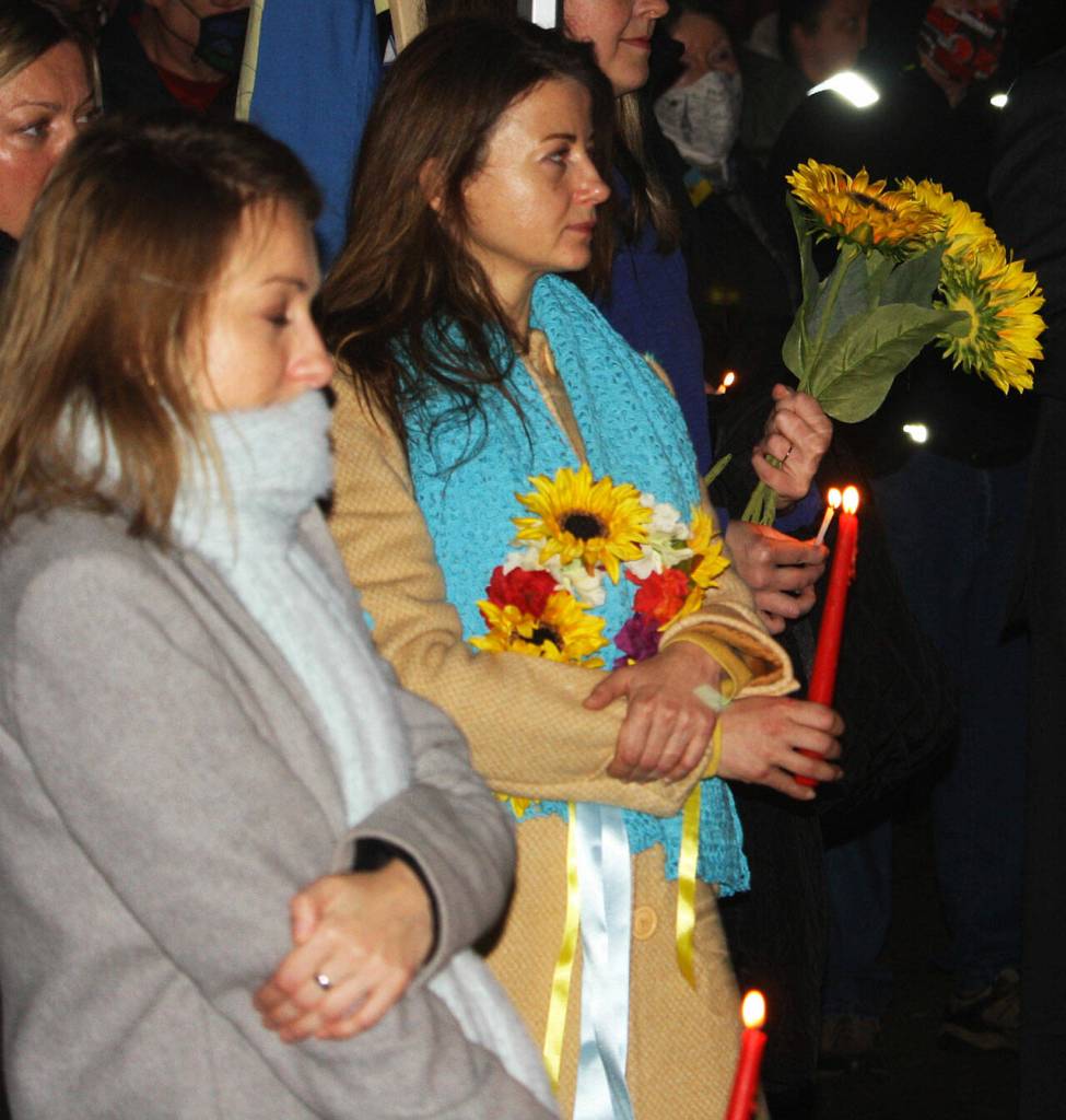 People show their support during a candlelight vigil for Ukraine outside of Kent City Hall. STEVE HUNTER, Kent Reporter