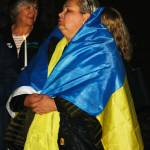 A woman wears the colors of the Ukrainian flag at the Kent City Hall courtyard on Tuesday, March 1 as part of an Unity for Ukraine rally. STEVE HUNTER, Kent Reporter