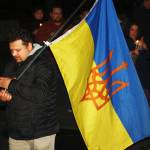 STEVE HUNTER, Kent Reporter
A man carries an Ukrainian flag at a rally Tuesday, March 1 outside Kent City Hall.