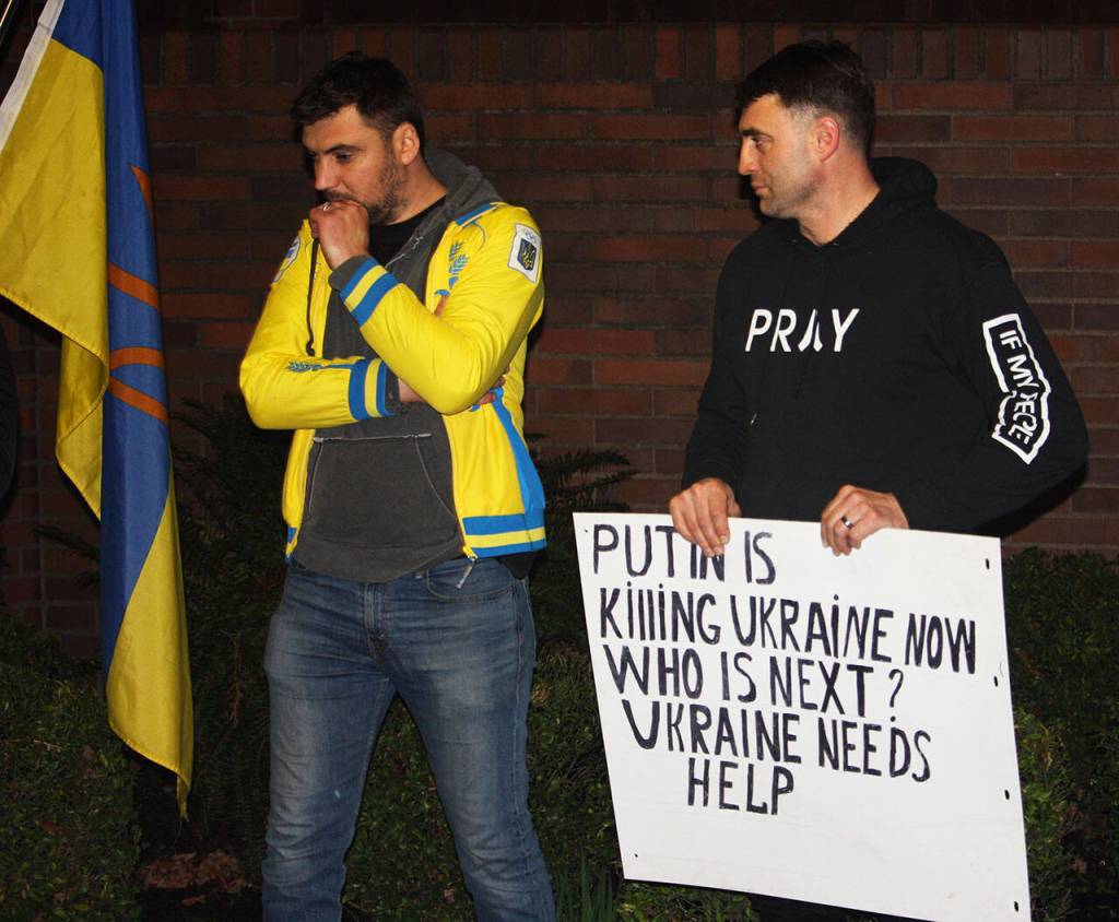 A man holds a sign with a clear message to Russian President Vladimir Putin. STEVE HUNTER, Kent Reporter