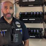 Cmdr. Adams of the Auburn Police Department demonstrates how to use the body-worn cameras. Screenshot courtesy of APD Twitter video