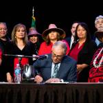 Tulalip council members and tribal members watch as Governor Jay Inslee signs bill HB 1571 into law at the Tulalip Resort on Thursday, March 31, 2022 in Tulalip, Washington. (Olivia Vanni / The Herald)